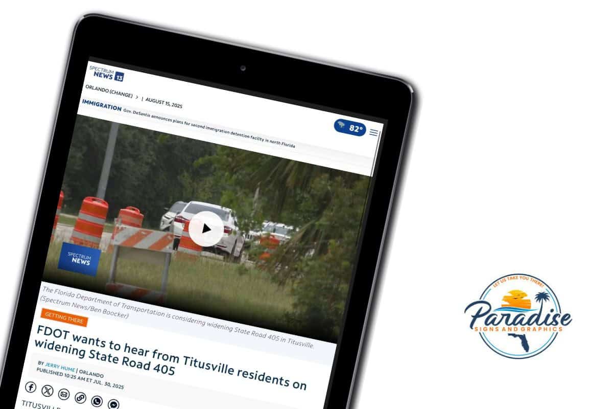 News article screenshot on a tablet with Paradise Signs and Graphics logo