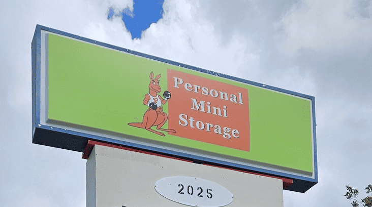 A sign with a kangaroo holding a box reads “Personal Mini Storage” on a green background, above the number 2025.