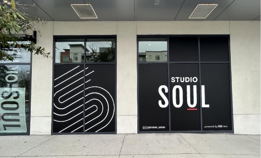 Storefront with large black and white signs displaying a stylized “S” design and the words “Studio Soul” on glass windows.