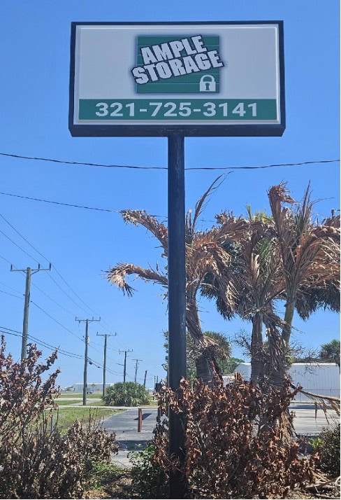 Sign for Ample Storage displaying the phone number 321-725-3141.