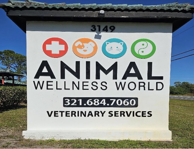 Sign for Animal Wellness World at 3149, including the phone number 321-684-7060 and the text “Veterinary Services.”