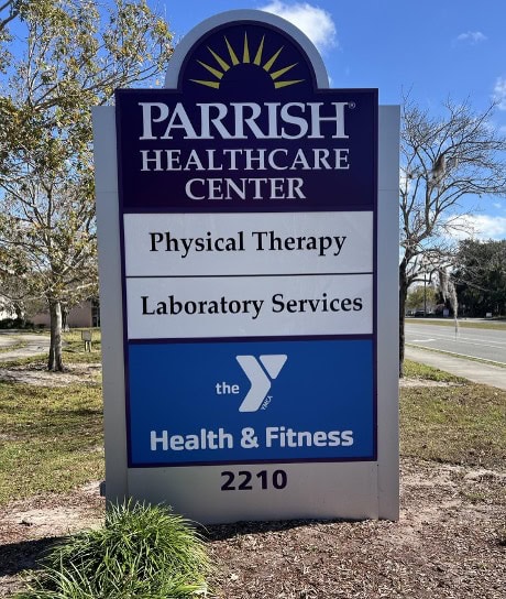 Sign for Parrish Healthcare Center listing Physical Therapy, Laboratory Services, and YMCA Health & Fitness, with the address 2210.